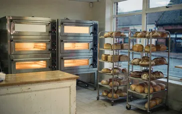 Bakery ovens glowing in a small shop before it opens